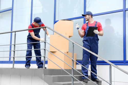Movers loading furniture carefully during house removals in Putney