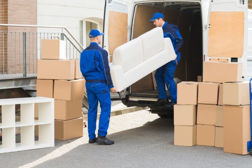 Professional removals crew following safe working standards