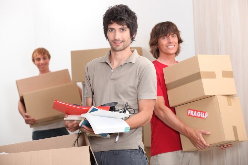 Professional movers carrying furniture for a Putney relocation