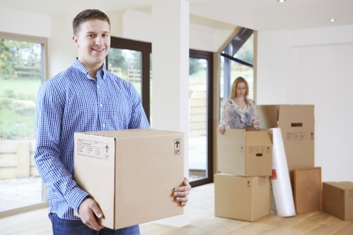 Moving team protecting sofas and tables during Putney furniture removals