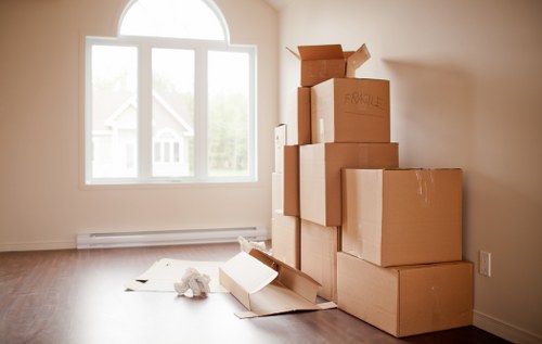 Staff member wearing PPE while loading furniture into a van