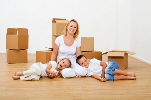 Experienced removalists in Putney unloading boxes at a new home