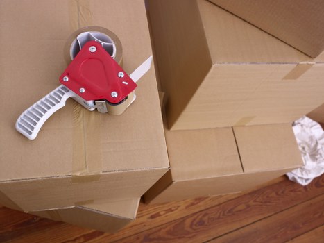 Professional movers handling household items inside a Putney property