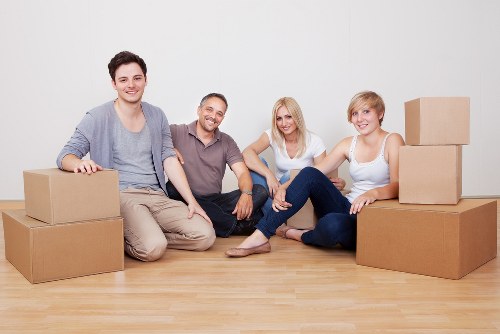 Packed boxes and furniture ready for a Putney removal van